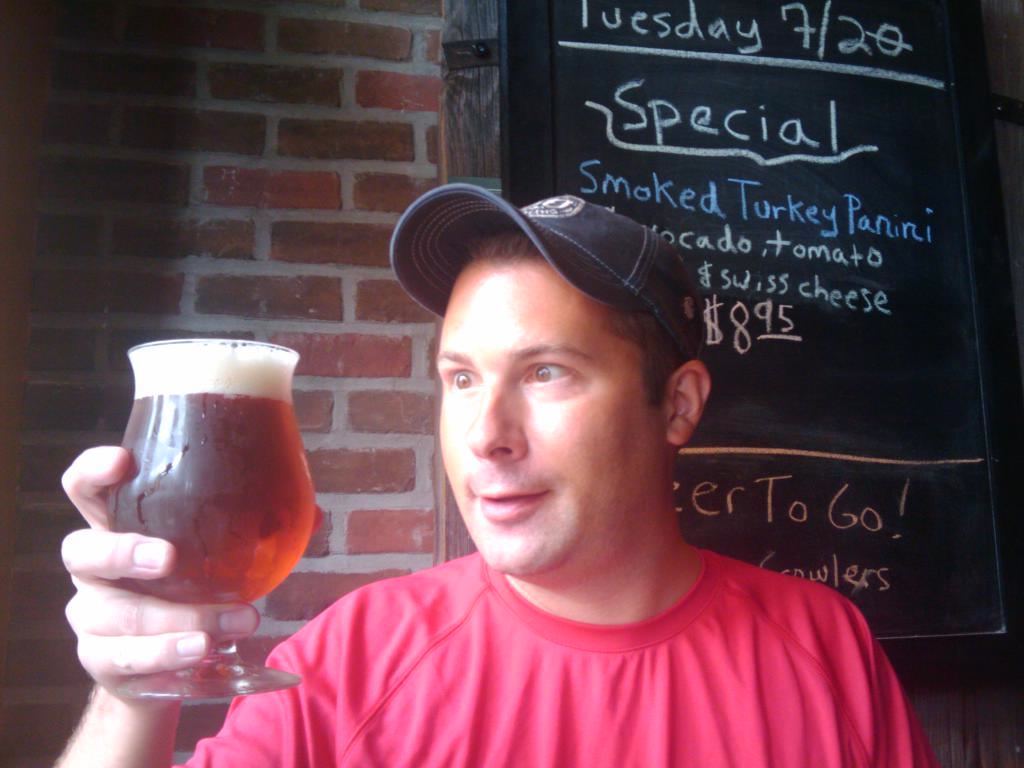 Riley McCormick holding craft beer at Bronx Ale House during Good Beer Seal Challenge, July 2010