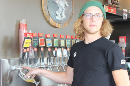 Bartender at Great Divide brewery tap wall during GABF tour, October 2012