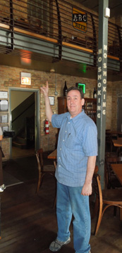 Michael Roper, owner of Chicago's Hopleaf Bar, standing in the bar interior, circa 2012