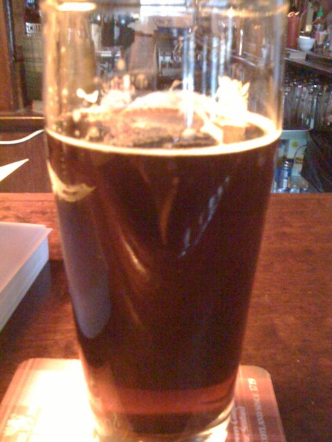 Dark craft beer with head in pint glass at Good Beer Seal bar, July 2010