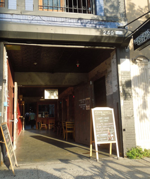 Mission Dolores beer bar storefront in Park Slope, circa 2012, with open entrance and sidewalk chalkboard menu