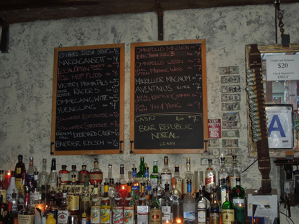 Mission Dolores bar interior with two chalkboard menus and bottles of spirits on shelves, August 2012