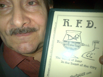 Man with mustache holding R.F.D. Beer menu at Craft Brewers Conference, 2013