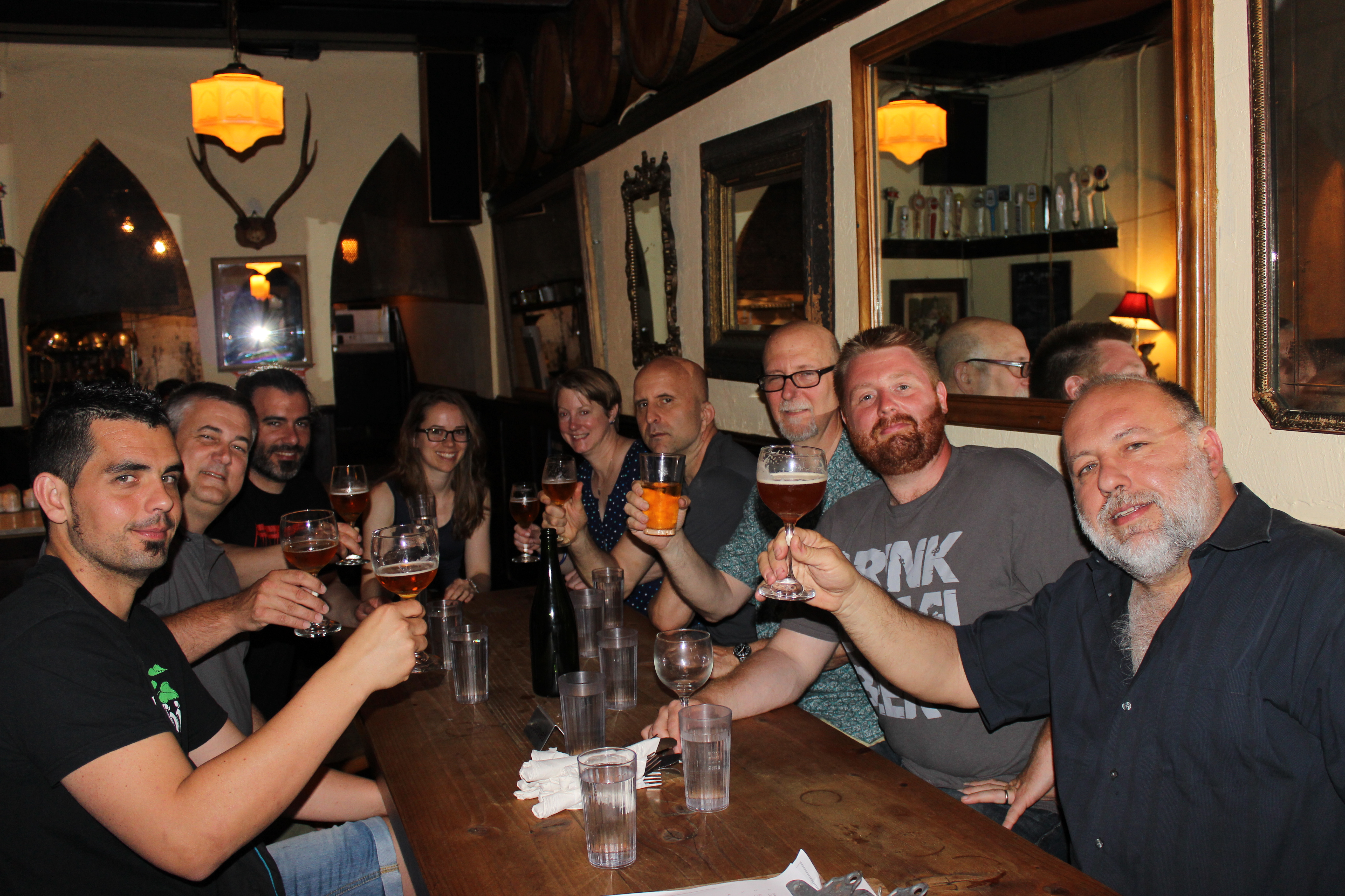Group of beer enthusiasts toasting with craft beers at Jimmy's No. 43, including Naparbier team and Shelton Brothers,...