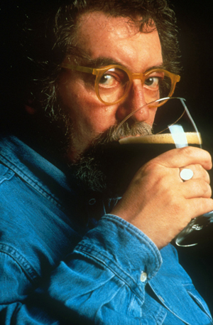 Michael Jackson, legendary beer critic, holding a glass of beer, circa 2012