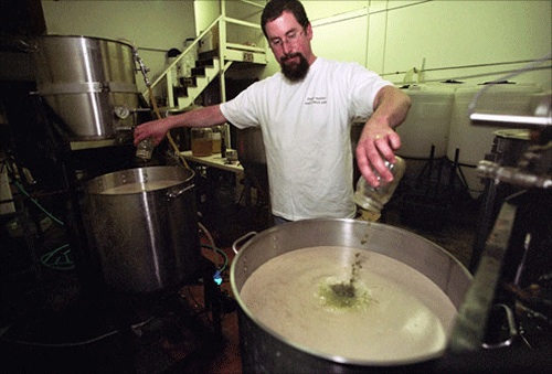 Bill Herlicka from White Birch Brewing pouring wort into brewing kettle, circa 2011